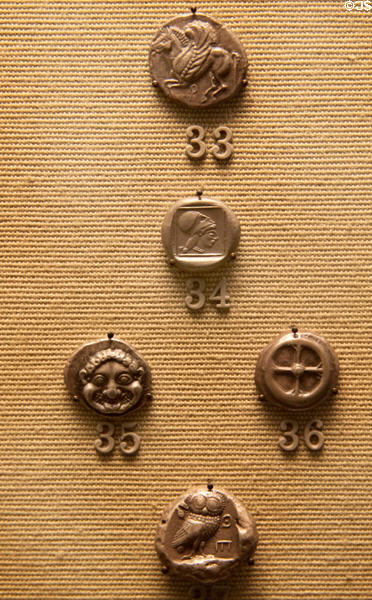 Silver coins from Corinth & Athens (c500-520 BCE) after new technology allowed Greeks to separate silver from lead ore at British Museum. London, United Kingdom.