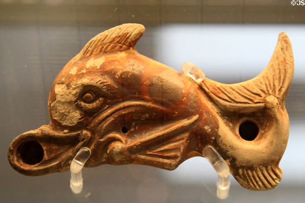 Terracotta oil lamp in form of dolphin (c30-80 CE) made in Italy at British Museum. London, United Kingdom.