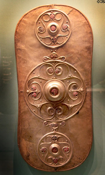 Celtic culture bronze shield with three raised decorative panels inlaid with red glass (350-50 BCE) found near Battersea Bridge in River Thames, London at British Museum. London, United Kingdom.