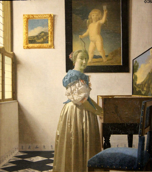 Young Woman standing at a Virginal painting (c1670-2) by Johannes Vermeer at National Gallery. London, United Kingdom.
