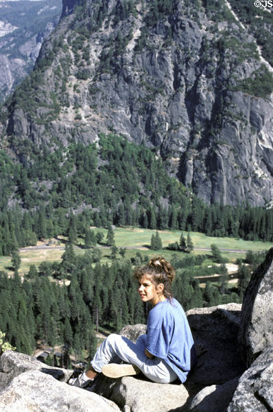 Hiker contemplates valley of Yosemite National Park. CA.