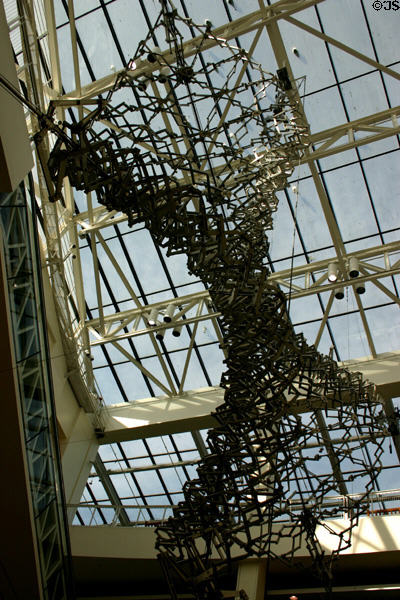Expanding metal sculpture against skylights of California Science Center. Los Angeles, CA.