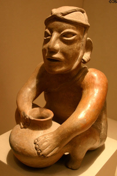 Jalisco Mexico: early-American Ameca gray style pottery vessel in form crouching man (c200 BCE- 300 CE) at LACMA. Los Angeles, CA.