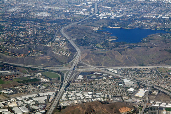 Aerial view of Interchange of San Bernadino, Orange & Chino Valley Freeways beside Puddingstone Reservoir. CA.
