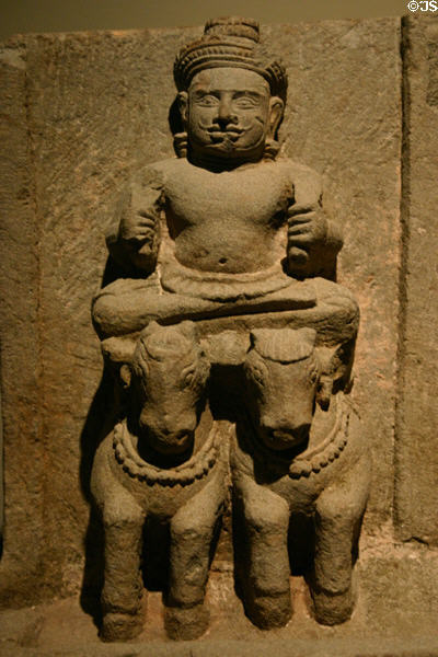 Surya sun god on horse-drawn chariot (10thC) of sculpted sandstone stele of planetary deities from Cambodia in Norton Simon Museum. Pasadena, CA.