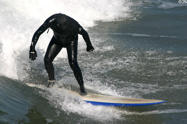 Standing on surf board in Ocean Beach. San Diego, CA.