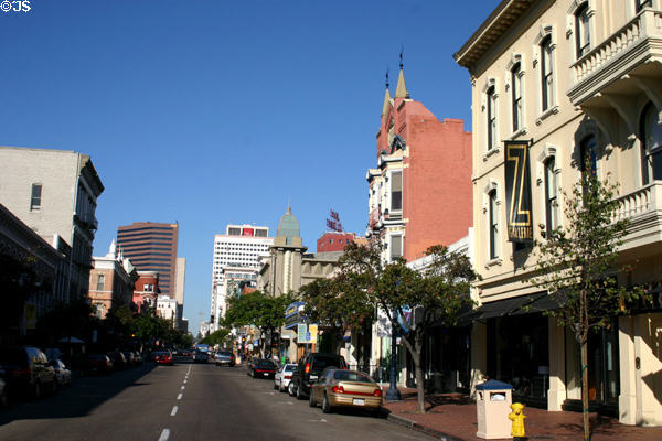 Heritage buildings along 5th Ave. of Gaslamp Quarter with highrises of downtown beyond. San Diego, CA.