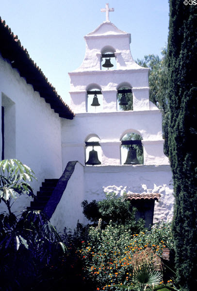 San Diego Mission adobe wall with bells seen from garden side. San Diego, CA.