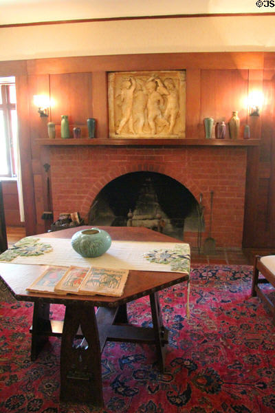 Arts & crafts wooden octagonal table in front of parlour fireplace at Marston House Museum. San Diego, CA.