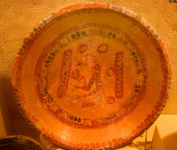 Mayan pottery three-legged plate (600-900) with seated man prob. from Campeche, Mexico at San Diego Museum of Man. San Diego, CA.