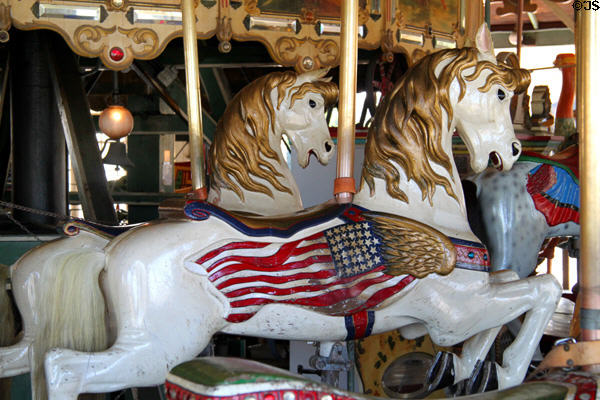 Carved horse with American flag on Balboa Park Carousel. San Diego, CA.