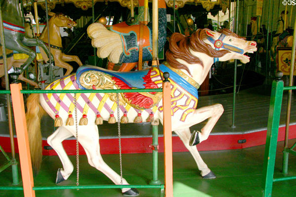 Carved horse with fancy saddle on Balboa Park Carousel. San Diego, CA.