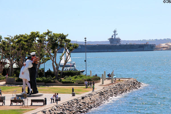 Unconditional Surrender giant sculpture of victory kiss & aircraft carrier seen from Midway. San Diego, CA.
