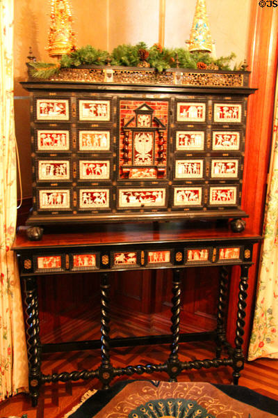 Cabinet with inlaid drawers on table with stretchers at Kimberly Crest House. Redlands, CA.