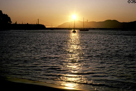 Setting sun over Golden Gate Bridge. San Francisco, CA.