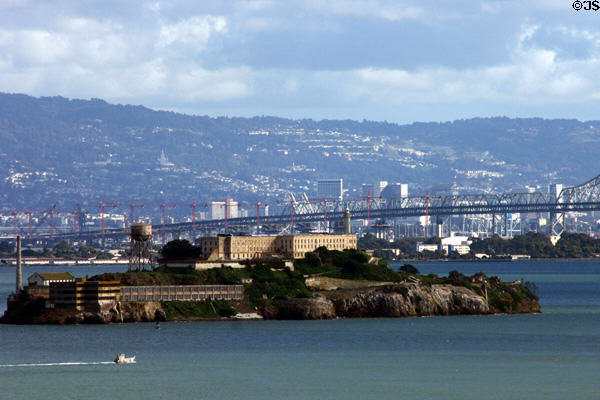 Non-suspension sections of Oakland Bay Bridge seen above Alcatraz & Treasure Islands & against Oakland skyline. San Francisco, CA.