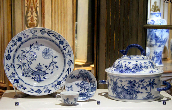 Porcelain blue onion plate (c1750); teacup (c1740-50) & covered tureen with fish handles (c1723-5) by Meissen Porcelain Manuf. of Germany at Legion of Honor Museum. San Francisco, CA.