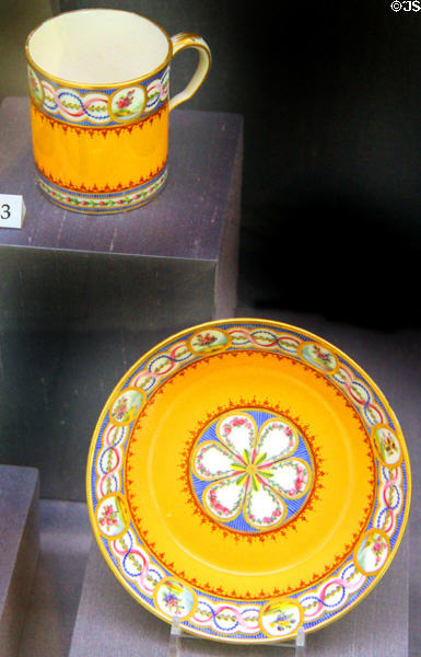 Porcelain cup & saucer in orange (1786) from Sèvres, France at Legion of Honor Museum. San Francisco, CA.