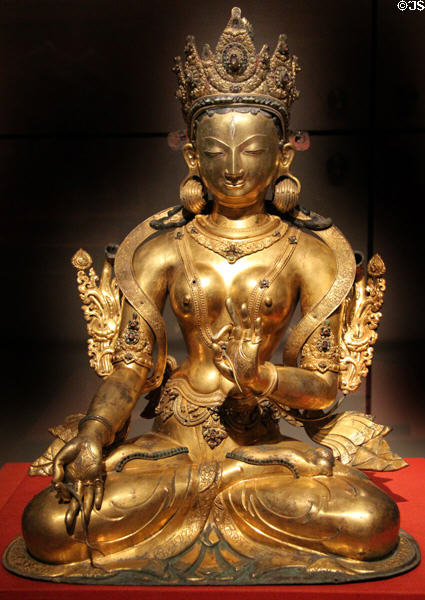 Buddhist deity White Tara gilded copper statue (1400-1500) from Nepal at Asian Art Museum. San Francisco, CA.