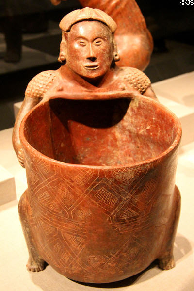 Colima earthenware seated figure holding bowl (300 BCE-300 CE) from West Mexico at de Young Museum. San Francisco, CA.
