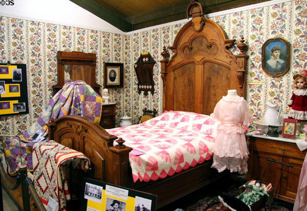 Ornately carved wooden Victorian bedstead & quilts at El Dorado County Historical Museum. Placerville, CA.