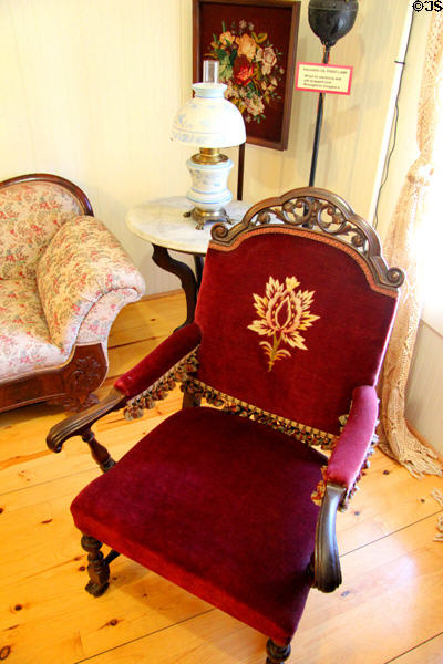 Arm chair in red velvet at Fountain & Tallman Museum. Placerville, CA.