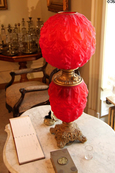 Red glass oil lamp on marble table at Pardee Home Museum. Oakland, CA.