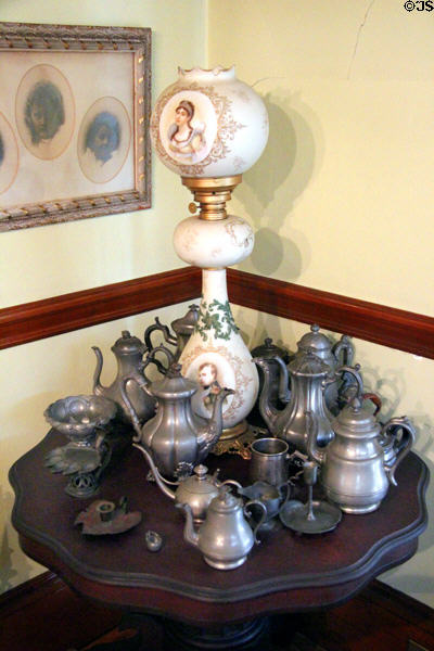 Napoleon & Juliette lamp among pewter coffeepots & objects at Pardee Home Museum. Oakland, CA.
