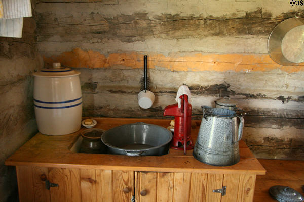 Kitchen water pump of settler's log cabin at Clear Creek History Park. Golden, CO.