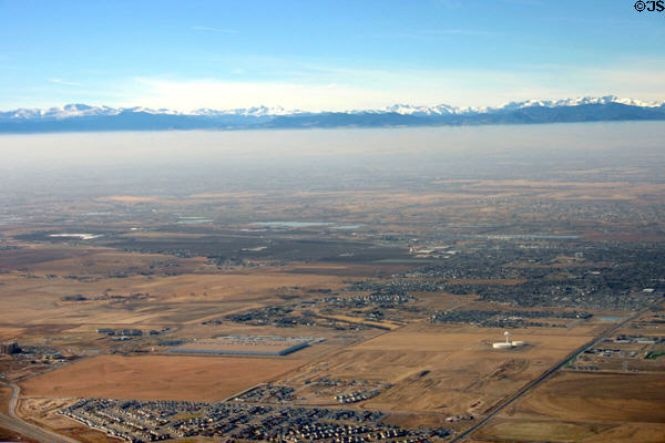 Rocky Mountain range above mist-covered Denver from air. Denver, CO.