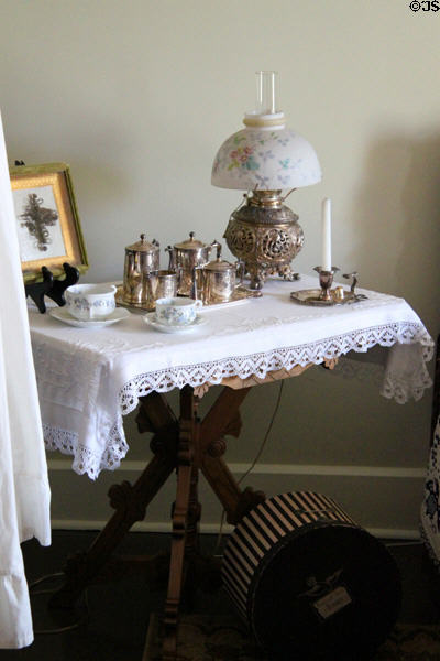 Table with lamp & coffee set at McAllister House Museum. Colorado Springs, CO.