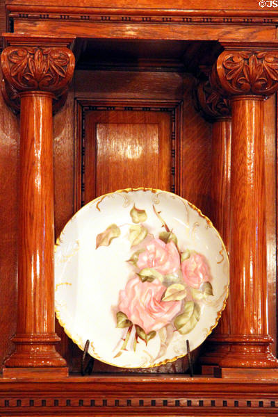 Porcelain plate with painted rose in dining room at Rosemount House Museum. Pueblo, CO.