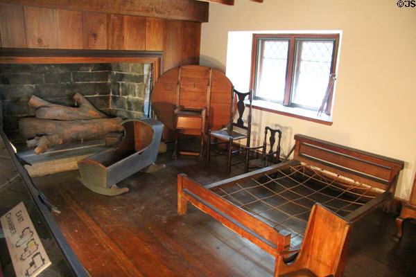 Upstairs east chamber with cradle, fold-down hutch table & rope bed at Henry Whitfield State Museum. Guilford, CT.