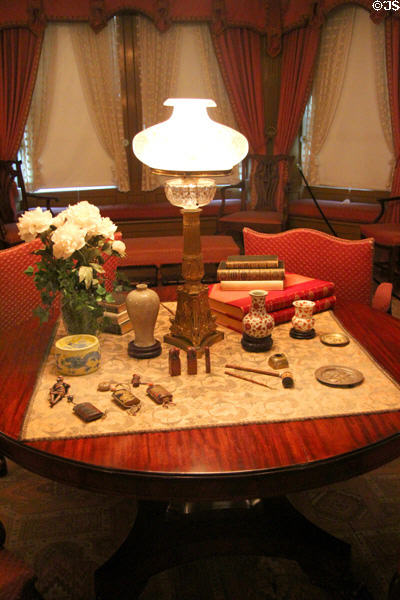 Empire-style table (c1890s) with Empire-style lamp plus collection of antique Oriental objects at Hill-Stead Museum. Farmington, CT.