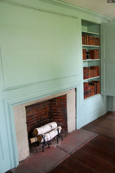 Fireplace with large wooden panel & bookcase at Oliver Ellsworth Homestead Museum. Windsor, CT.