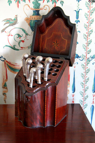 Knife box with pistol handle knives (1760-70) by Alexander Gairdner of Edinburgh against reproduction wallpaper at Phelps-Hathaway House. Suffield, CT.