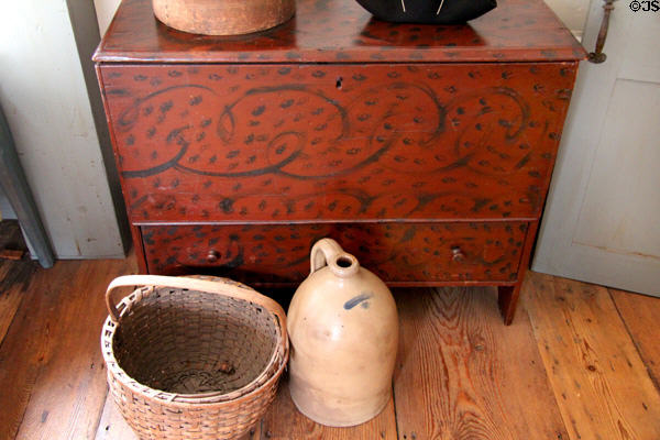 Chest with painted swirled decoration with basket & stoneware jug at Silas Deane House. Wethersfield, CT.