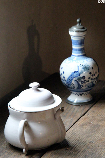 White posset pot (18thC) for mix of curdled milk & wine beside ewer painted with peacock (18thC) both from England at Buttolph-Williams House. Wethersfield, CT.