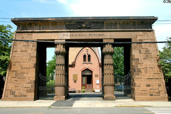 Grove Street Cemetery Entrance (1845) plus 1872 Gothic chapel with bee symbolizing released souls behind. New Haven, CT. Style: Egyptian Revival. Architect: Henry Austin. On National Register.