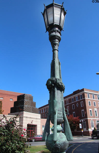 Bronze lampstand supported by sculpted canon & four rifles at Waterbury Soldiers Monument. Waterbury, CT.