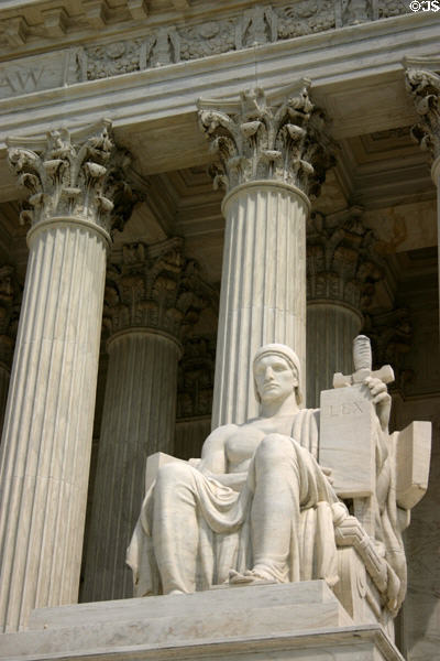 Sculpture of seated man holding sword & LEX tablet in front of Supreme Court building. Washington, DC.