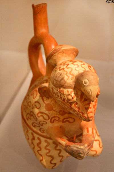 Moche ceramic stirrup-spout bottle figure of Wrinkle Face with bird headdress (100-800) from Peru at Dumbarton Oaks Museum. Washington, DC.