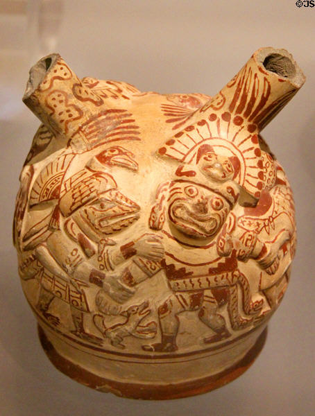 Moche ceramic stirrup-spout bottle figure of Wrinkle Face being held by arms by supernatural bird (100-800) from Peru at Dumbarton Oaks Museum. Washington, DC.