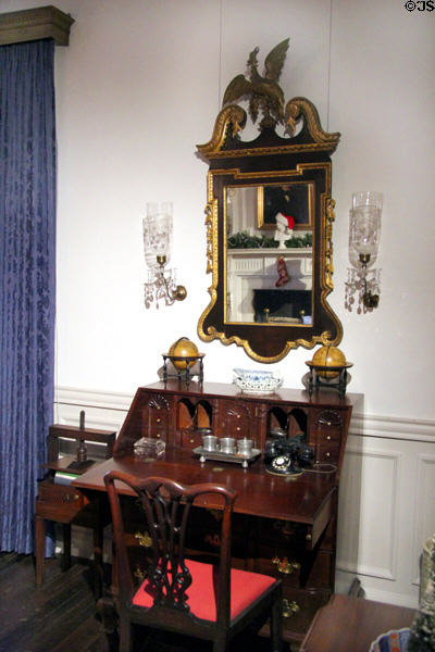 Block front desk with pigeon holes & drawers (c1770) from Salem or Boston under reproduction American looking glass in Indiana period parlor at DAR Memorial Continental Hall. Washington, DC.