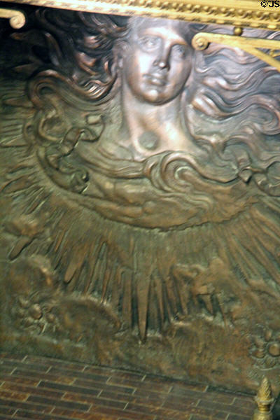 Front room fireplace metal back shield depicts sun god at Christian Heurich Mansion. Washington, DC.