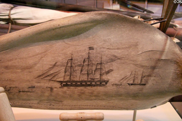 Scrimshaw panbone (part of sperm whale's jaw) shows whale hunt of coast of Ternate in Indonesia at National Museum of American History. Washington, DC.