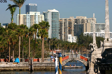 Condo buildings line Biscayne Bay beyond Vizcaya waterfront. Miami, FL.