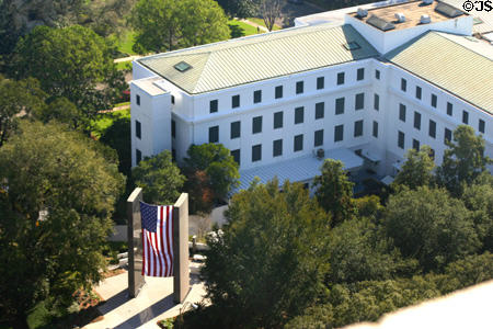 Flag hangs before building in state capitol complex seen from above. Tallahassee, FL.