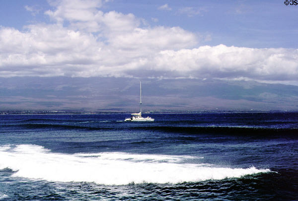 Boat crosses horizon on Ma'alaea Bay. Maui, HI.