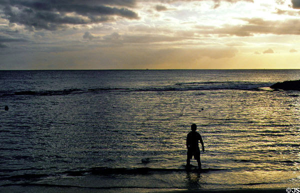 Fishing native-style during sunset at Paradise Cove. Oahu, HI.